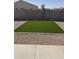 Low-maintenance backyard features new artificial turf and desert landscaping at 15120 S Amado Blvd, Arizona City, AZ 85123