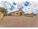 Spacious backyard featuring gravel, a covered patio, and well-maintained block wall fencing at 15120 S Amado Blvd, Arizona City, AZ 85123