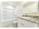 Bright bathroom featuring a modern vanity with granite counter and shower-tub combo at 15120 S Amado Blvd, Arizona City, AZ 85123