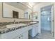Bright bathroom featuring double vanity with granite counters and walk-in shower at 15120 S Amado Blvd, Arizona City, AZ 85123