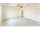 Spacious bedroom featuring tiled floors, a ceiling fan, and an open doorway to the en-suite bathroom at 15120 S Amado Blvd, Arizona City, AZ 85123