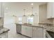 Open-concept kitchen with granite countertops and stainless steel sink overlooking the living area at 15120 S Amado Blvd, Arizona City, AZ 85123