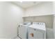 Laundry room featuring a washing machine, dryer, and ample shelf space at 15120 S Amado Blvd, Arizona City, AZ 85123