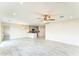 Spacious living room showcasing a ceiling fan and an open layout connecting to the kitchen at 15120 S Amado Blvd, Arizona City, AZ 85123