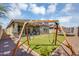 Gathering-friendly backyard with a swing set, lush turf, and stone accents, perfect for outdoor activities at 15133 W Moreland St, Goodyear, AZ 85338