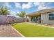 Spacious backyard with artificial turf, a swing set, and gravel accents for low-maintenance outdoor fun at 15133 W Moreland St, Goodyear, AZ 85338