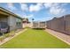 Well-maintained backyard featuring artificial grass, a trampoline, and privacy wall for year-round enjoyment at 15133 W Moreland St, Goodyear, AZ 85338