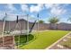 Backyard featuring a trampoline and swing set, perfect for outdoor fun and games at 15133 W Moreland St, Goodyear, AZ 85338