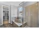 Bathroom featuring a glass enclosed shower, a separate bathtub, and walk-in closet at 15133 W Moreland St, Goodyear, AZ 85338