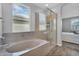 Bathroom featuring a glass enclosed shower and a separate bathtub at 15133 W Moreland St, Goodyear, AZ 85338