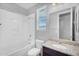 Bathroom with granite countertop, toilet, vanity mirror, and shower-tub combo at 15133 W Moreland St, Goodyear, AZ 85338
