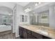 Bathroom features double sink vanity with granite countertops, and a walk-in shower at 15133 W Moreland St, Goodyear, AZ 85338