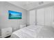 Bright bedroom with ceiling fan, TV, two bedside tables, and double door closet at 15133 W Moreland St, Goodyear, AZ 85338
