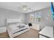 Bedroom with a ceiling fan, windows, and minimalist decor at 15133 W Moreland St, Goodyear, AZ 85338