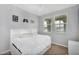 Cozy bedroom with neutral walls, ceiling fan, and comfortable bed with headboard and windows at 15133 W Moreland St, Goodyear, AZ 85338