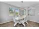 Bright dining room features a modern white table, chairs, and unique light fixture at 15133 W Moreland St, Goodyear, AZ 85338