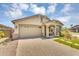 Attractive single-Gathering home with an attached garage, stone accents, and well-manicured landscaping at 15133 W Moreland St, Goodyear, AZ 85338