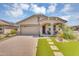 Beautiful single-story home featuring a lush lawn, a two-car garage, and a covered entryway at 15133 W Moreland St, Goodyear, AZ 85338