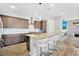 Large kitchen island with seating, modern appliances, pendant lights, and earth-toned cabinets at 15133 W Moreland St, Goodyear, AZ 85338