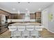 Spacious kitchen boasts a large center island with seating, pendant lighting, and modern appliances at 15133 W Moreland St, Goodyear, AZ 85338