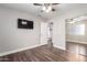 This room features a ceiling fan, wood floors, and a closet with mirrored sliding doors at 17606 N 2Nd Ave, Phoenix, AZ 85023