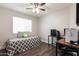 Bedroom includes a gaming setup, comfortable bed, hardwood floors, and ceiling fan at 17606 N 2Nd Ave, Phoenix, AZ 85023