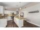 Modern kitchen with stainless steel appliances, granite counters, and dark wood flooring at 17606 N 2Nd Ave, Phoenix, AZ 85023