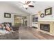 Comfortable living room with a fireplace, a sliding glass door leading to the backyard, and wood floors at 17606 N 2Nd Ave, Phoenix, AZ 85023