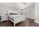 Bright main bedroom with a vaulted ceiling, rich wood floors, a comfortable bed, and plenty of natural light at 17606 N 2Nd Ave, Phoenix, AZ 85023