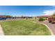View of the community exterior with green space, flowering bushes, and parking at 20250 N 6Th Dr # 3, Phoenix, AZ 85027