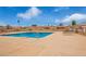 Community pool featuring lounge chairs, tables, blue water, and a clear sky, perfect for relaxation at 20250 N 6Th Dr # 3, Phoenix, AZ 85027