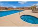 Community pool featuring lounge chairs, umbrella and an adjacent spa for ultimate relaxation at 20250 N 6Th Dr # 3, Phoenix, AZ 85027