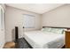 Cozy bedroom with a queen-size bed, neutral walls, and a window with wood-style flooring at 2062 S Emerson --, Mesa, AZ 85210