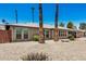 This home has desert landscaping with lush bushes in the front yard with palm trees at 2062 S Emerson --, Mesa, AZ 85210