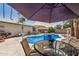 This backyard with a blue pool, patio table, and BBQ grill is perfect for outdoor dining at 2062 S Emerson --, Mesa, AZ 85210