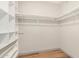 Walk-in closet with wood floors and white shelving, ready for storage and organization at 2062 S Emerson --, Mesa, AZ 85210