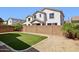 Private backyard featuring artificial turf, gravel landscaping, and a block wall for added privacy at 2096 S Moccasin Trl, Gilbert, AZ 85295