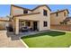 Attractive backyard featuring low-maintenance artificial turf, a covered patio, and outdoor living space at 2096 S Moccasin Trl, Gilbert, AZ 85295