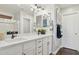 Bright bathroom boasts double vanity, quartz counters, framed mirrors, and modern fixtures at 2096 S Moccasin Trl, Gilbert, AZ 85295