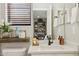 Well-lit bathroom vanity with a decorative shelf, mirror, and natural light for a refreshing space at 2096 S Moccasin Trl, Gilbert, AZ 85295