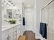 Bathroom featuring double sinks, white cabinets, framed mirrors, and a glass shower at 2096 S Moccasin Trl, Gilbert, AZ 85295