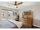 Bedroom with wooden dresser, ceiling fan, and window with neighborhood views at 2096 S Moccasin Trl, Gilbert, AZ 85295