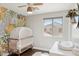 Adorable Bedroom features a white crib, decorative wallpaper and a cozy atmosphere, perfect for your new baby at 2096 S Moccasin Trl, Gilbert, AZ 85295