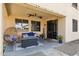 Relaxing covered patio with comfortable seating, a modern ceiling fan, and a stylish welcome sign at 2096 S Moccasin Trl, Gilbert, AZ 85295