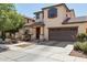 Inviting two-story home with covered porch, two-car garage, and well-maintained landscaping at 2096 S Moccasin Trl, Gilbert, AZ 85295