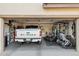 Spacious two-car garage featuring a parked white Ford F-150, gym equipment, and ample storage space for organization at 2096 S Moccasin Trl, Gilbert, AZ 85295