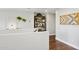 Bright hallway features hardwood floors, decorative shelving, and stylish wall decor, creating a welcoming transition space at 2096 S Moccasin Trl, Gilbert, AZ 85295