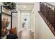 Welcoming hallway with hardwood floors, staircase, and views into the home's dining area at 2096 S Moccasin Trl, Gilbert, AZ 85295