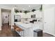 Bright kitchen with white cabinets, stainless steel appliances, and a quartz island with seating at 2096 S Moccasin Trl, Gilbert, AZ 85295