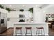 Modern kitchen with white cabinetry, stainless steel appliances, and breakfast bar seating at 2096 S Moccasin Trl, Gilbert, AZ 85295